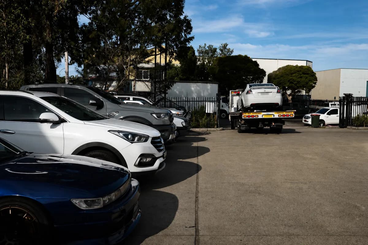 Rev'd Up's yard with the tow truck and customer vehicles in for service